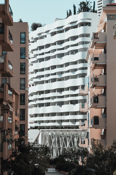 Two brown building near the white concrete building
